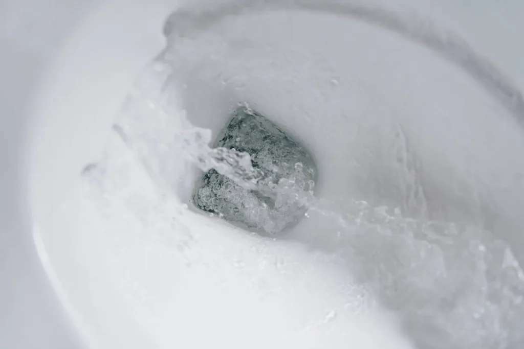 Toilet bowl with water actively flushing down