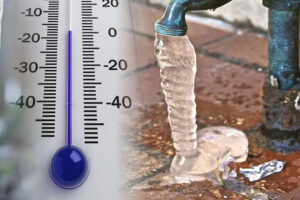 Thermometer showing 0 degrees next to a frozen hose bib with an icicle forming